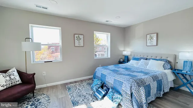 a bedroom with a bed couch and window