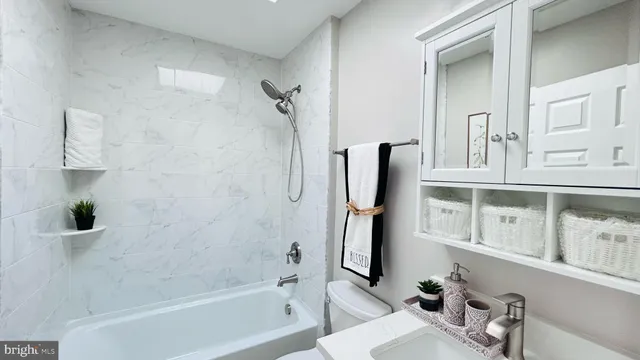 a bathroom with a sink a toilet and a bathtub