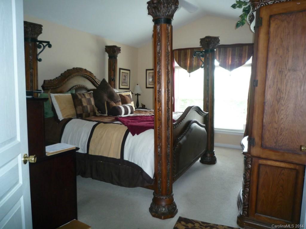 3102 Tanzanite Circle Fort Mill, SC 29708 - Photo 11 of 18 a bedroom with a bed and a chandelier