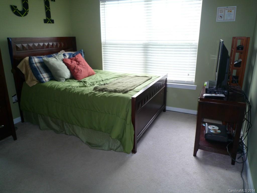 3102 Tanzanite Circle Fort Mill, SC 29708 - Photo 13 of 18 a bedroom with a bed and a flat tv screen on dresser
