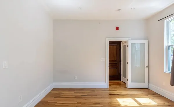 a view of room with wooden floor