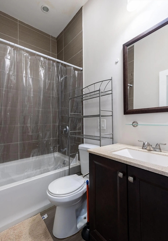 89 Cedar Street, Unit 2 Boston, MA 02119 - Photo 25 of 27 a bathroom with a sink a toilet and shower