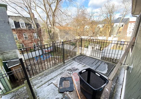 a view of a balcony with wooden floor