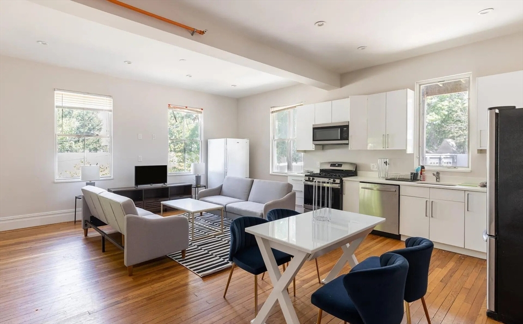 89 Cedar Street, Unit 2 Boston, MA 02119 - Photo 3 of 27 a living room with furniture appliances wooden floor and a window