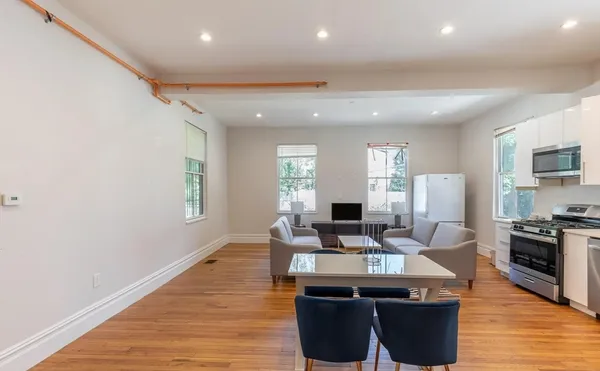a view of a kitchen with kitchen island granite countertop a sink counter top space and stainless steel appliances