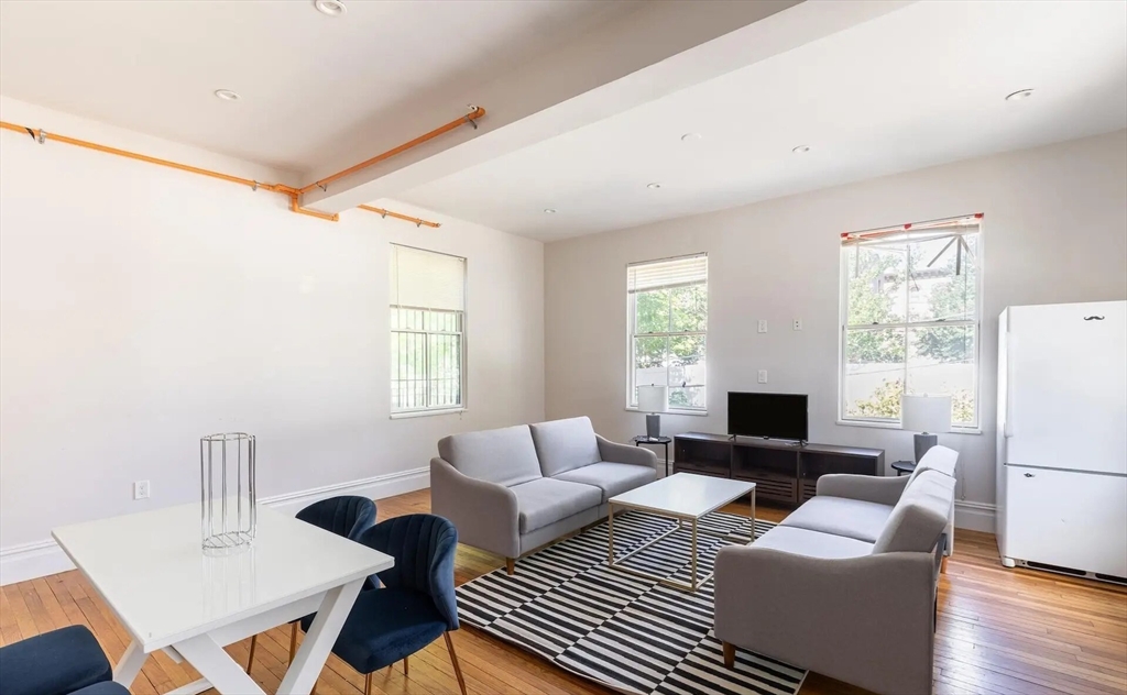 89 Cedar Street, Unit 2 Boston, MA 02119 - Photo 5 of 27 a living room with furniture and a table