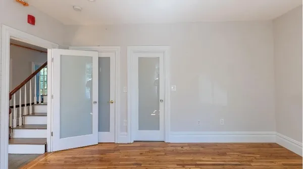 a view of bedroom with wooden floor