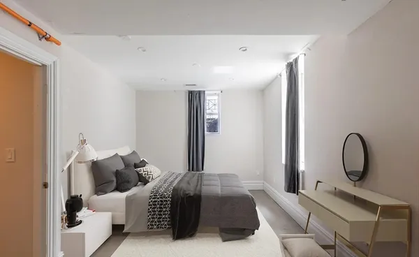 a bedroom with bed and a large window