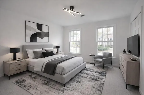 a bedroom with a bed and a flat screen tv