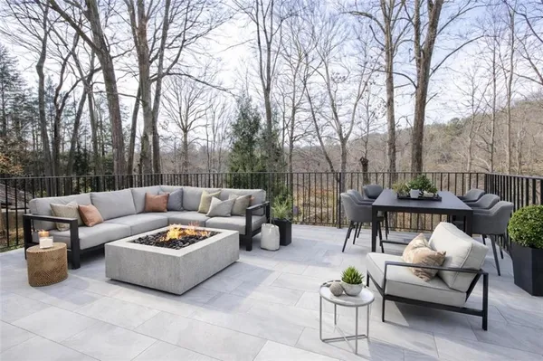 a view of a patio with couches and a table and chairs
