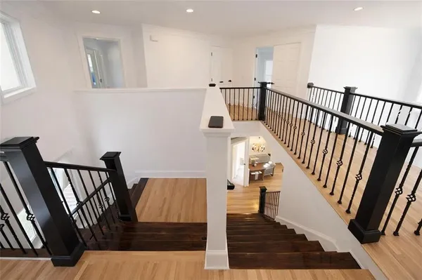 a view of entryway and hall with wooden floor