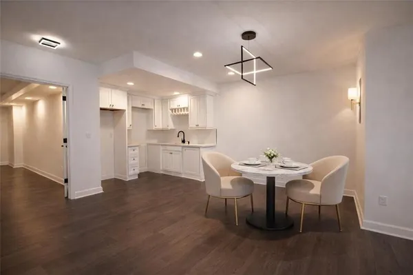 a view of a dining room with furniture and wooden floor