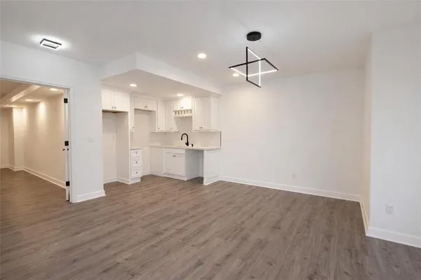 a view of a kitchen with a sink and refrigerator