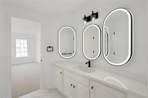 a bathroom with mirror and sink