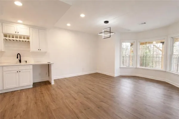 a view of a kitchen with wooden floor and a sink