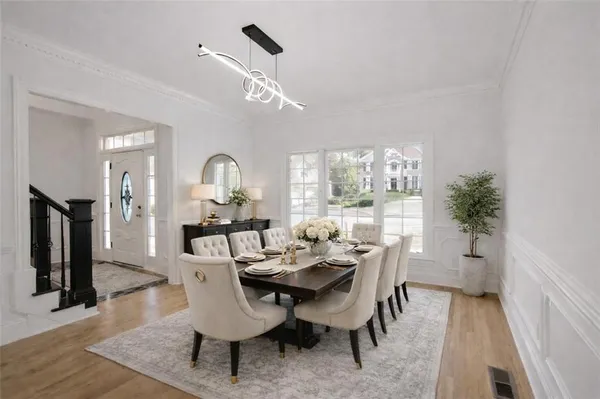 a view of a dining room with furniture and wooden floor