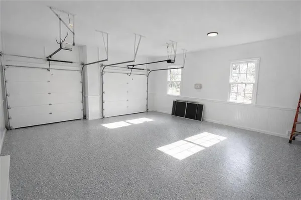 an empty room with windows and fireplace