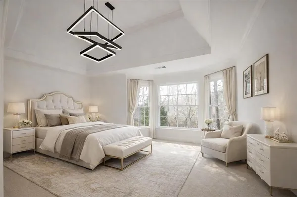 a spacious bedroom with a bed a couch and a window