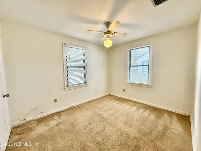 a view of hallway with wooden floor