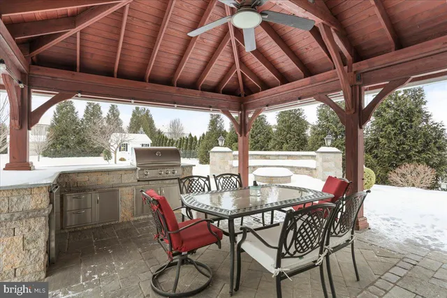 a backyard of a house with fire pit and outdoor seating