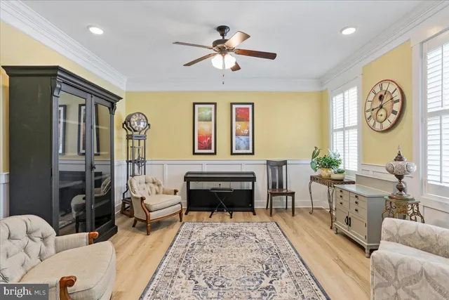 a living room with furniture a chandelier and a rug