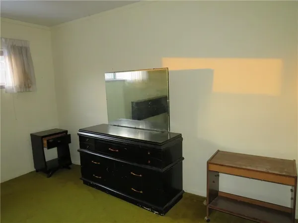 a room with a dresser and a window
