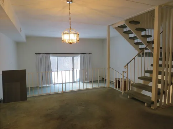 a view of an empty room with stairs