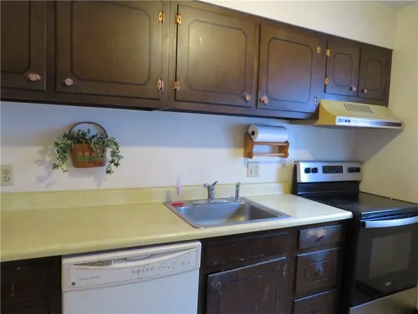 a kitchen with a sink cabinets and wooden floor