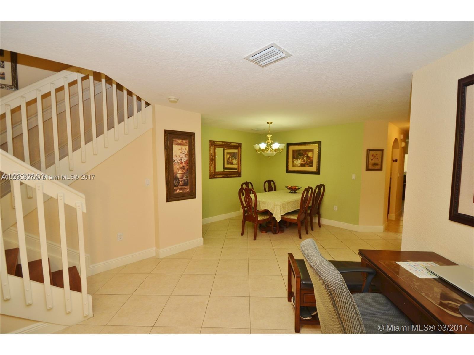 3153 Southwest 129th Terrace, Unit 161 Miramar, FL 33027 - Photo 11 of 17 a living room with furniture and a dining table