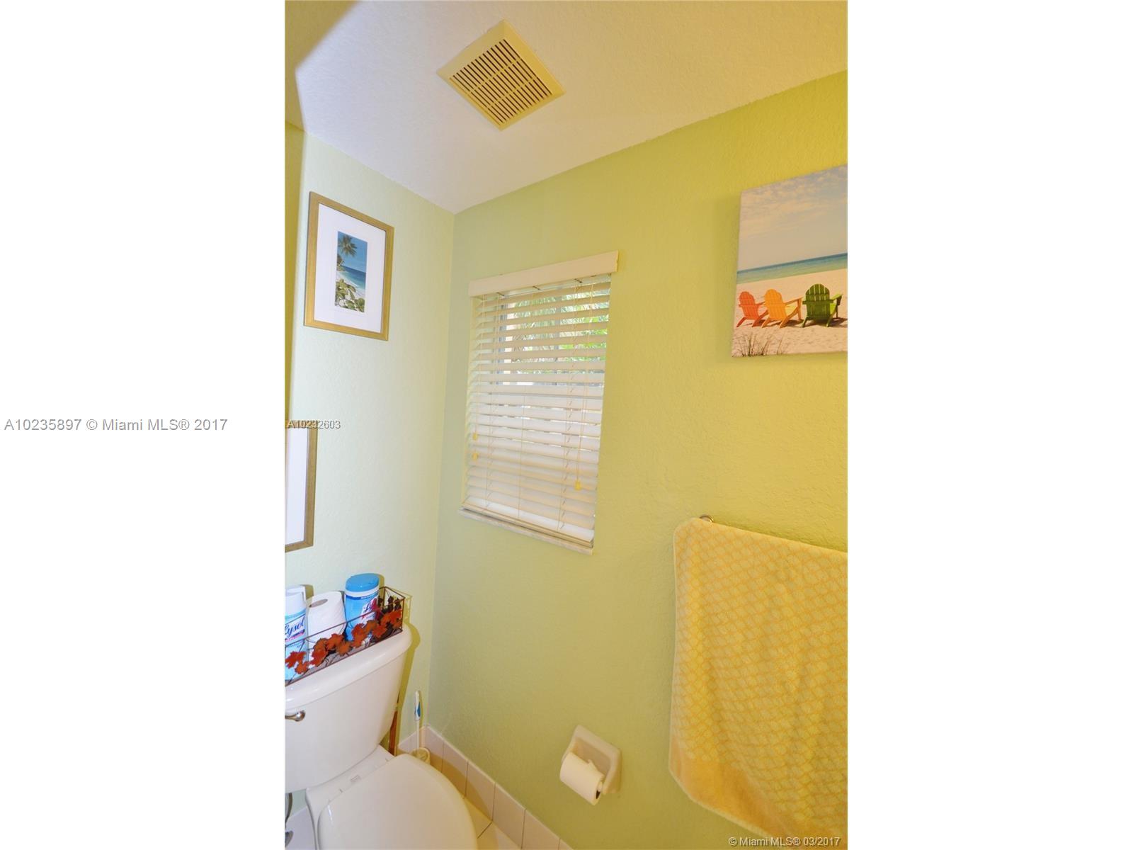 3153 Southwest 129th Terrace, Unit 161 Miramar, FL 33027 - Photo 15 of 17 a bathroom with a sink and a mirror