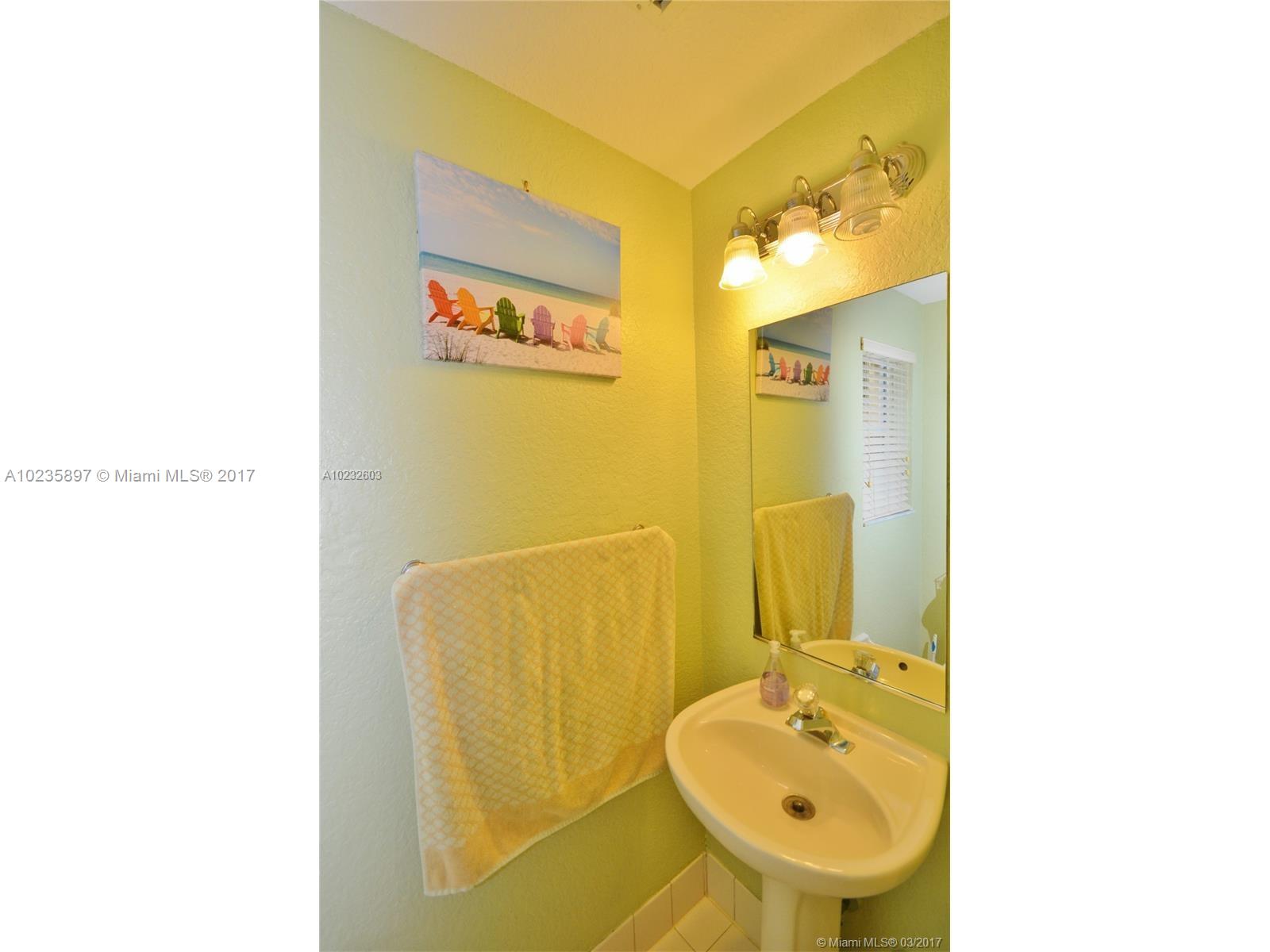 3153 Southwest 129th Terrace, Unit 161 Miramar, FL 33027 - Photo 16 of 17 a bathroom with a sink and a mirror