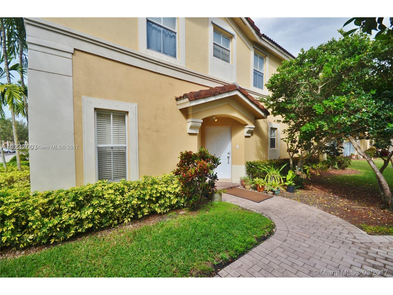 3153 Southwest 129th Terrace, Unit 161 Miramar, FL 33027 - Photo 2 of 17 a front view of a house with a yard