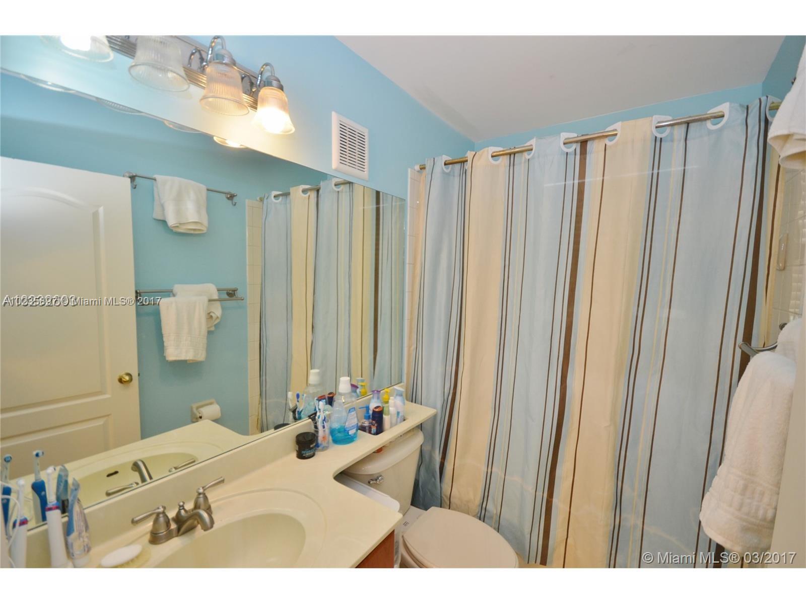 3153 Southwest 129th Terrace, Unit 161 Miramar, FL 33027 - Photo 7 of 17 a bathroom with a bathtub and a sink