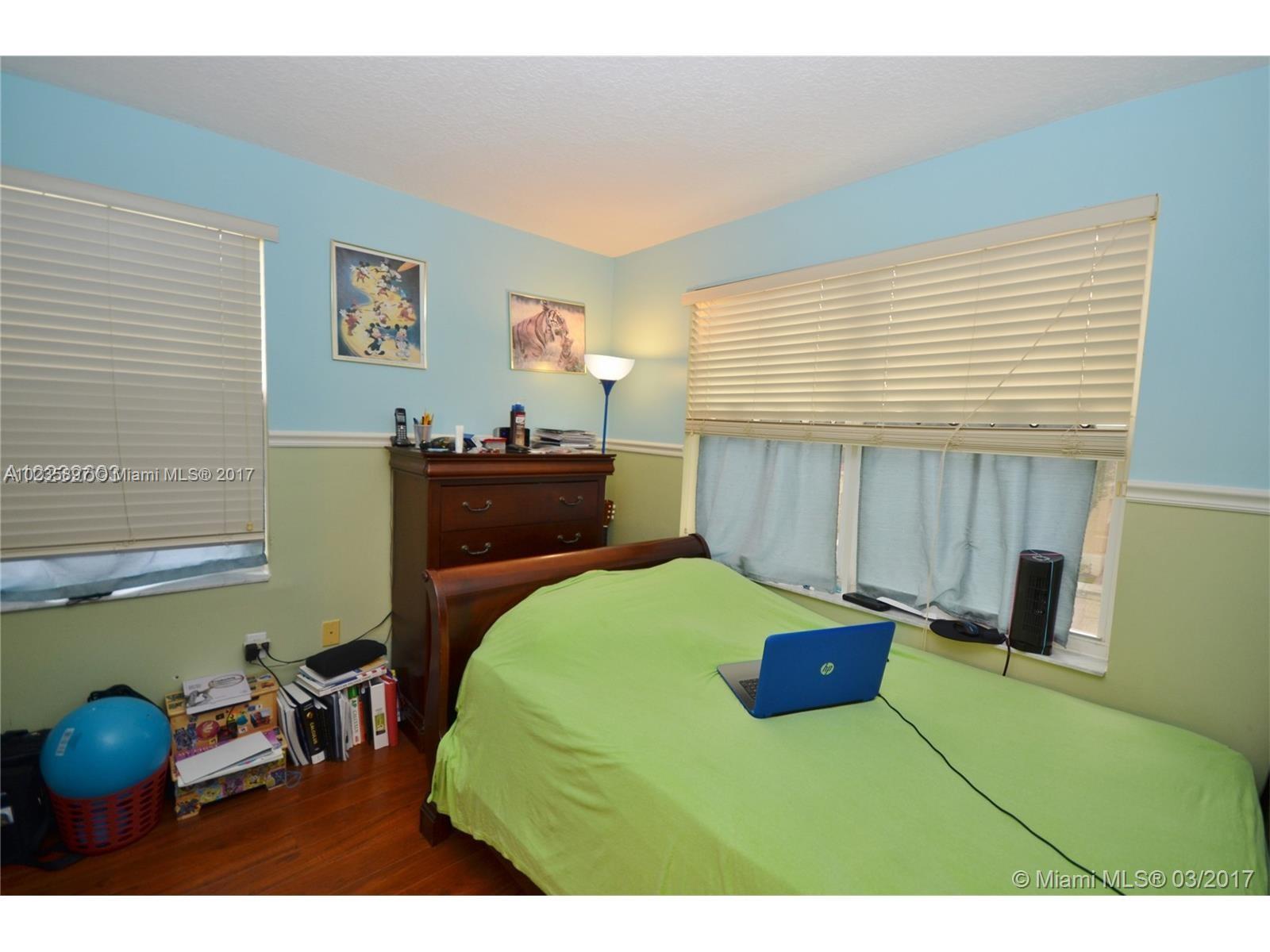 3153 Southwest 129th Terrace, Unit 161 Miramar, FL 33027 - Photo 9 of 17 a bedroom with a bed and a dresser