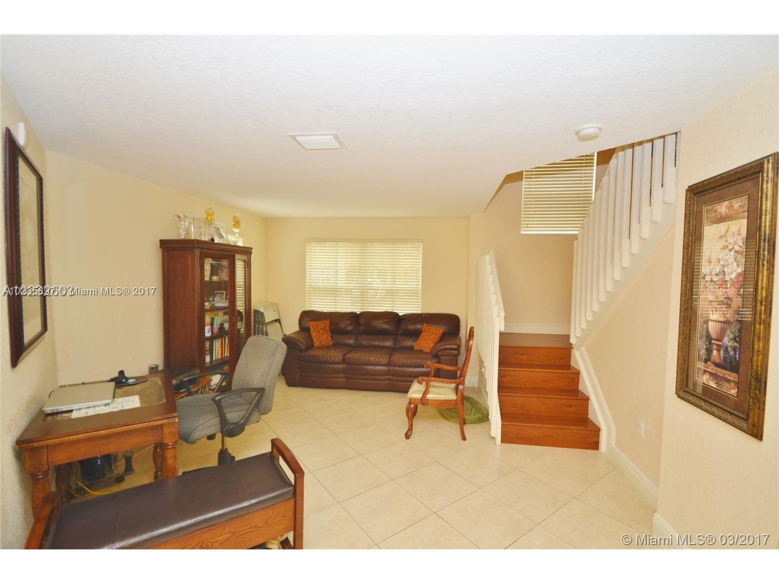 3153 Southwest 129th Terrace, Unit 161 Miramar, FL 33027 - Photo 10 of 17 a living room with furniture and a flat screen tv