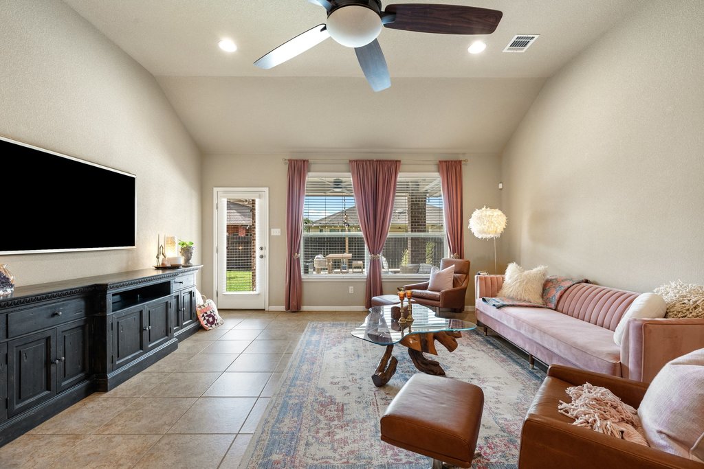13808 Field Stream Lane Manor, TX 78653 - Photo 17 of 39 Living area with a ceiling fan, lofted ceiling, light tile patterned flooring, and recessed lighting
