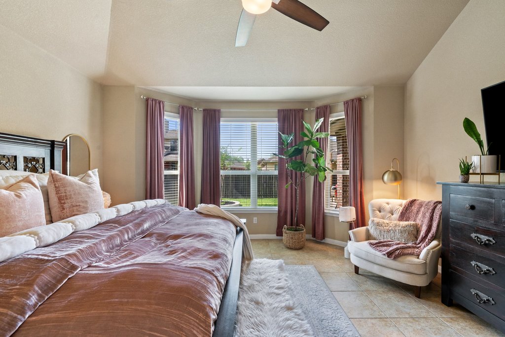 13808 Field Stream Lane Manor, TX 78653 - Photo 21 of 39 Bedroom with lofted ceiling, a ceiling fan, and light tile patterned flooring