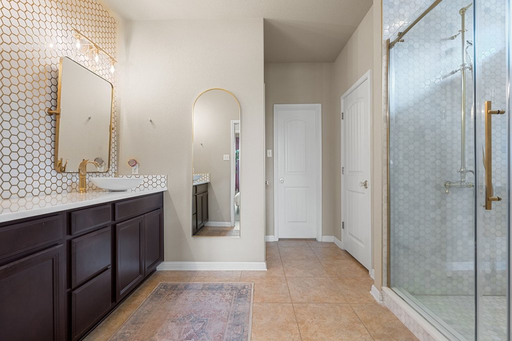 13808 Field Stream Lane Manor, TX 78653 - Photo 23 of 39 Bathroom with vanity, a stall shower, and light tile patterned floors