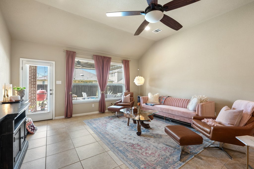 13808 Field Stream Lane Manor, TX 78653 - Photo 3 of 39 Living room with a ceiling fan, lofted ceiling, and light tile patterned floors