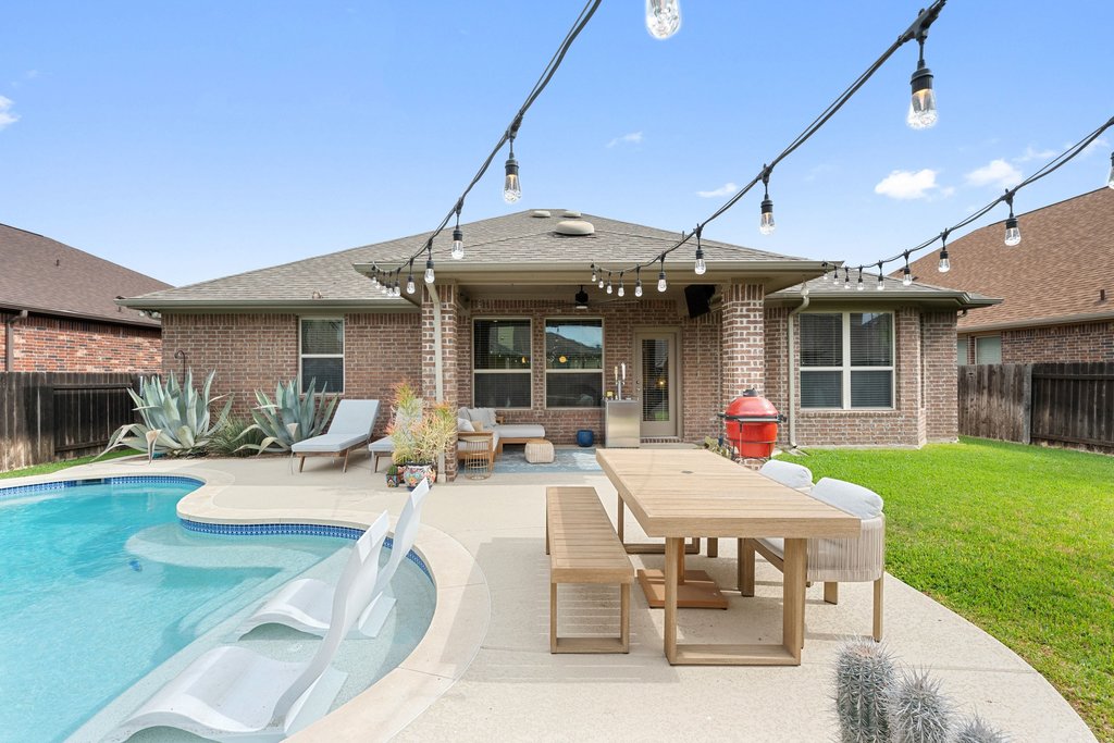 13808 Field Stream Lane Manor, TX 78653 - Photo 32 of 39 Rear view of property with a fenced backyard, brick siding, a patio area, a shingled roof, and an outdoor hangout area