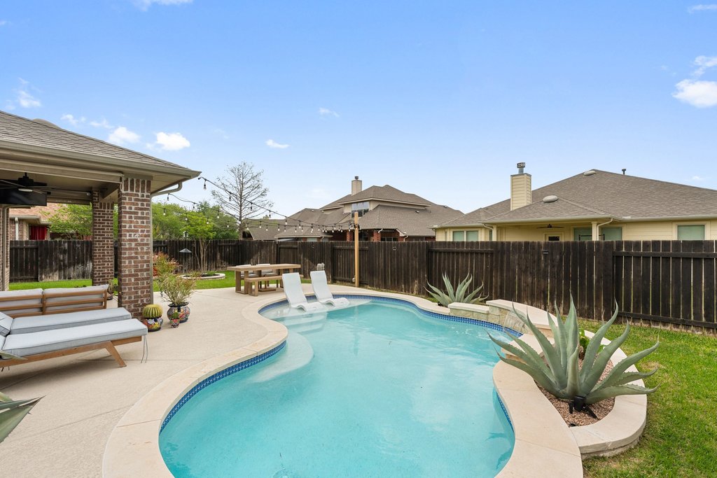 13808 Field Stream Lane Manor, TX 78653 - Photo 33 of 39 View of swimming pool with patio surround and a fenced backyard