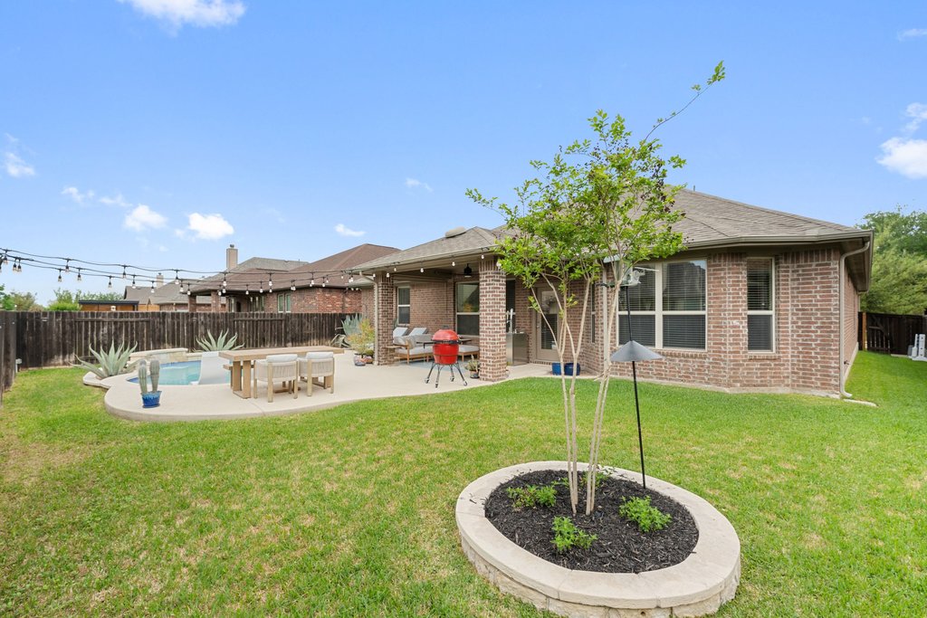 13808 Field Stream Lane Manor, TX 78653 - Photo 36 of 39 Rear view of property with a fenced backyard, a patio, brick siding, and roof with shingles