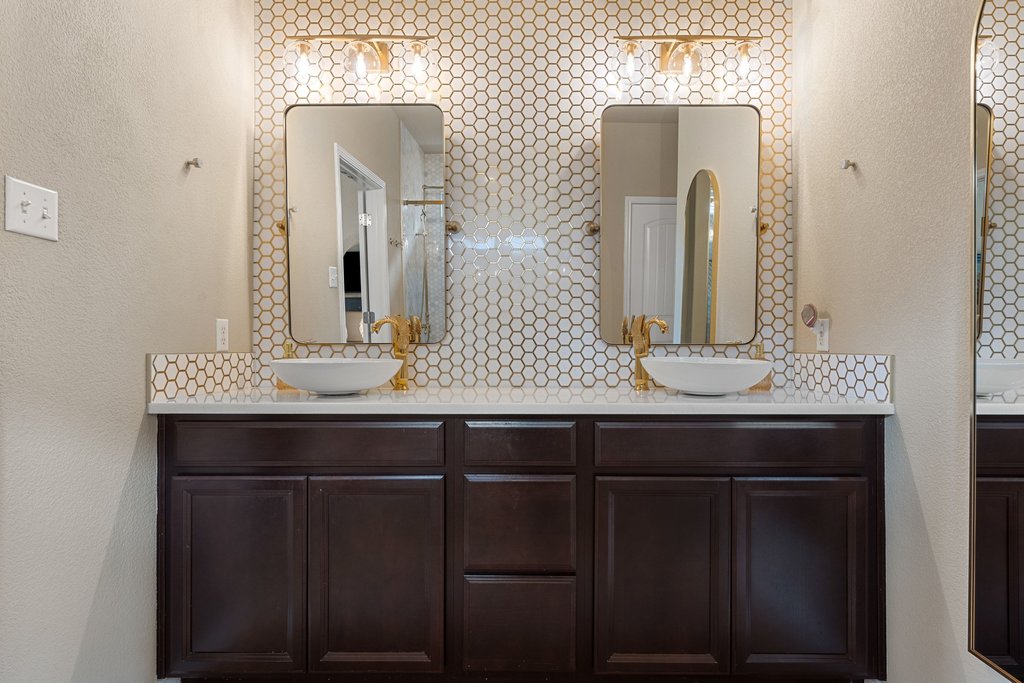 13808 Field Stream Lane Manor, TX 78653 - Photo 5 of 39 Bathroom featuring a textured wall, double vanity, and decorative backsplash