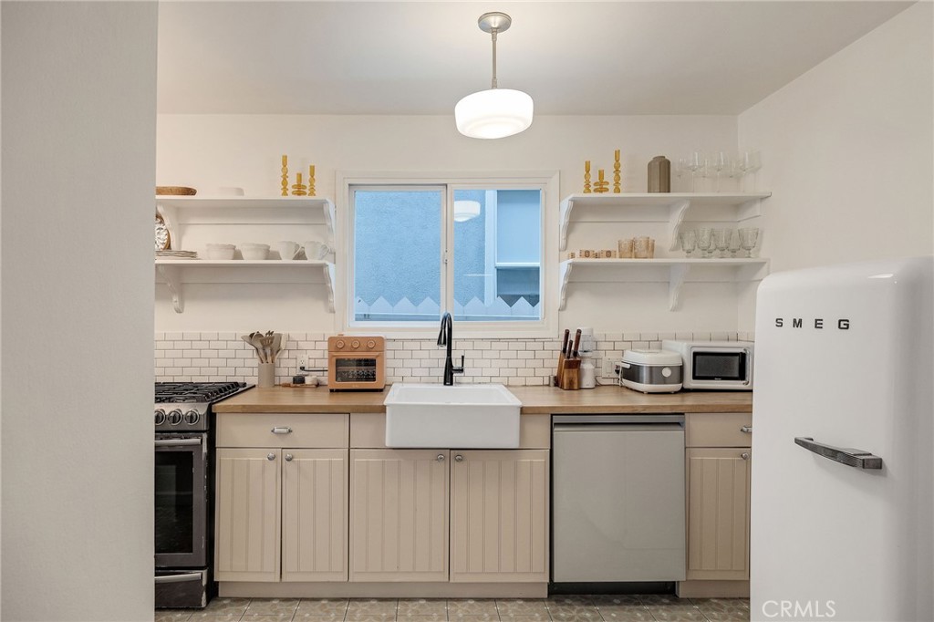 1706 Carver Street Redondo Beach, CA 90278 - Photo 12 of 40 a kitchen with kitchen island granite countertop a sink cabinets and stainless steel appliances