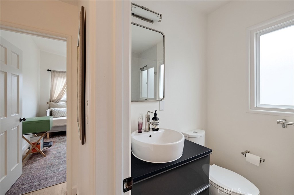 1706 Carver Street Redondo Beach, CA 90278 - Photo 36 of 40 a bathroom with a toilet a sink and mirror