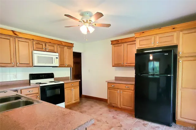 a kitchen with a refrigerator sink and stove