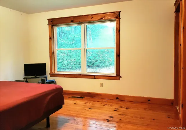 a bedroom with a bed and large window