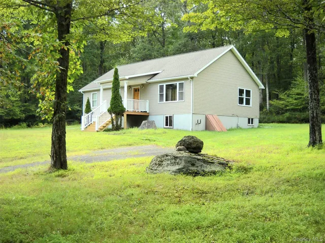 a front view of house with yard and green space
