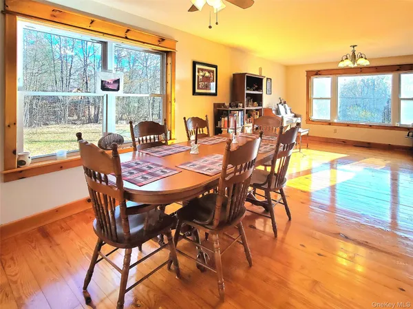 a dining room with furniture and wooden floor