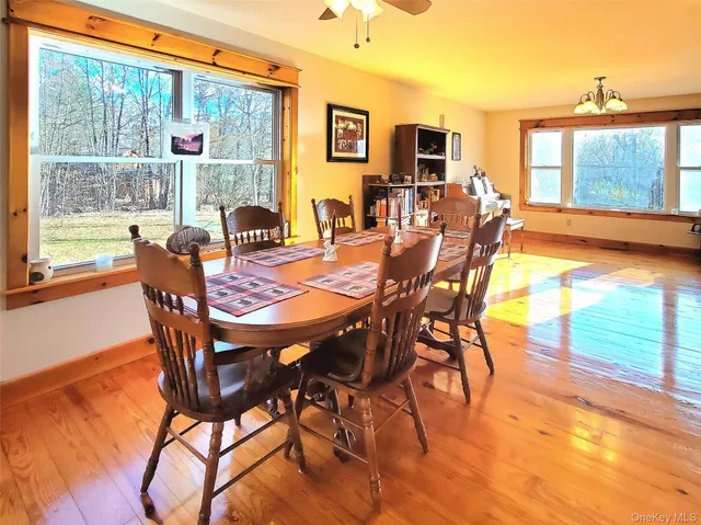 a dining room with furniture and wooden floor